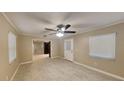 Inviting living room featuring tile floors, neutral paint, ample natural light, and an overhead ceiling fan at 699 Sullivan St, Deltona, FL 32725