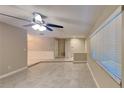 Open-concept living room with tiled flooring, natural light from the windows, and a modern ceiling fan at 699 Sullivan St, Deltona, FL 32725
