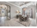 Formal dining room with stylish chandelier, elegant decor, and a large window for natural light at 1035 Stoney Creek Dr, Lakeland, FL 33811