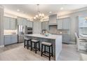 Modern kitchen featuring stainless steel appliances, a center island with seating, and stylish gray cabinetry at 1035 Stoney Creek Dr, Lakeland, FL 33811