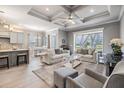 Inviting living room with coffered ceilings, neutral decor, and a large window overlooking the backyard at 1035 Stoney Creek Dr, Lakeland, FL 33811
