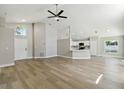 Bright living room with sleek, modern floors and an open concept to the kitchen at 133 Grovepark Dr, Davenport, FL 33837