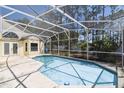 Relaxing screened-in pool with ample space for patio furniture and lounging at 133 Grovepark Dr, Davenport, FL 33837