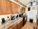 Functional kitchen featuring modern appliances, laminate countertops and wooden cabinets at 4746 Wales St, Lake Wales, FL 33859