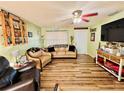 Cozy living room with hardwood floors, comfortable seating, ceiling fan and bright natural light at 4746 Wales St, Lake Wales, FL 33859
