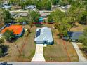 Aerial view of property lines, a home with solar panels, and surrounding landscaping at 12164 Se 85Th Ct, Belleview, FL 34420