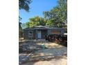 Cozy single story home features a simple front facade, white door, and new grey roof at 332 W 8Th St, Lakeland, FL 33805