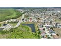 This aerial view of the community highlights the lush landscaping and scenic pond at 634 Canna Dr, Davenport, FL 33897