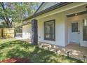 Exterior showcasing stone accents, neat landscaping, and a covered front porch, creating a welcoming entrance at 130 Stag Ridge Ct, Longwood, FL 32779