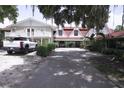 Charming exterior of a multi-story home with well-maintained landscaping and a long driveway leading to ample parking at 201 Lake Bonny E Dr, Lakeland, FL 33801