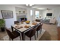 Open-concept dining room boasts marble table, fireplace, and abundant natural light at 3632 Mockingbird Ln, Orlando, FL 32803