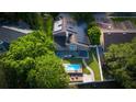 Beautiful aerial view of home with solar panels, outdoor patio, and inviting pool at 1315 Olympia Park Cir, Ocoee, FL 34761