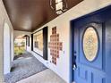 Welcoming entrance featuring a blue door, decorative tiles, and modern lighting at 1968 Pleasant Hill Rd, Kissimmee, FL 34746