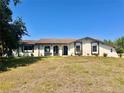 Charming one-story home with a well-maintained lawn and unique architectural elements at 1968 Pleasant Hill Rd, Kissimmee, FL 34746