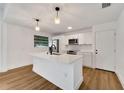 Bright and spacious kitchen featuring a large island, stainless steel appliances, and modern finishes at 800 N Church Ave, Mulberry, FL 33860