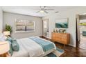 Bright bedroom featuring a wooden dresser, ensuite bathroom, and soothing beach-themed decor at 4012 Shorecrest Dr, Orlando, FL 32804