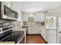 Modern kitchen with stainless steel appliances, granite countertops, and wood floors at 4012 Shorecrest Dr, Orlando, FL 32804