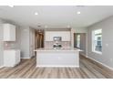 Bright, modern kitchen featuring a central island with quartz countertop and stainless appliances at 6784 Sw 90Th Loop, Ocala, FL 34476