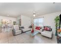 Open-concept living room featuring stylish decor, tiled floors, and comfortable seating arrangements for entertaining at 947 Serchio St, Haines City, FL 33844