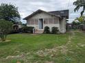 Single story home with a well-manicured lawn and an open door in a neighborhood setting at 1529 Indiana St, Orlando, FL 32805