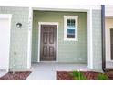 Charming home featuring a welcoming front door, well-kept landscaping, and stylish exterior details at 3273 Vesara Dr, Davenport, FL 33837