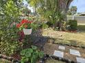 Secluded backyard features lush foliage, potted plants, and a wrought iron bench at 3446 Country Manor Dr, Port Orange, FL 32129