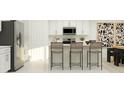 Bright kitchen with white cabinetry, stainless steel appliances, and a counter with bar stool seating for casual dining at 2315 Scarlet Ave, Winter Haven, FL 33884