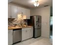 Modern kitchen features stainless steel appliances, stylish backsplash, and ample cabinet space at 3601 Ne 24Th Ct, Ocala, FL 34479