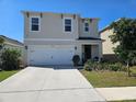 Charming two-story home featuring a two-car garage and well-manicured front yard at 1204 Berry Ln, Davenport, FL 33837