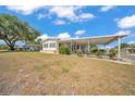 Charming single-story home featuring a carport and a cozy front porch and yard with mature tree at 1610 Reynolds Rd # 353, Lakeland, FL 33801