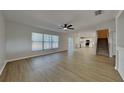 Bright living room with ceiling fan flows seamlessly into the adjacent kitchen area at 6918 Lake Eaglebrooke Dr, Lakeland, FL 33813