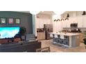 Open-concept living area features a spacious kitchen, cozy seating, and modern decor at 753 Grand Hilltop Dr, Apopka, FL 32703
