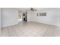 An open concept floor plan features tiled flooring and neutral walls with backyard access at 222 Aldo Dr, Babson Park, FL 33827