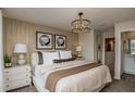 Serene main bedroom with decorative wall, modern lighting, and ensuite bathroom access at 3819 King Hill Dr, Haines City, FL 33844