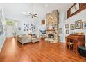 Cozy living room with a stone fireplace and wood floors at 917 Keep Way Loop, Oviedo, FL 32765