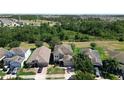 Aerial view of a home surrounded by lush greenery and neighboring houses in a suburban setting at 1705 Plantation Pointe Dr, Orlando, FL 32824