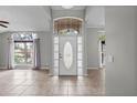 Bright foyer showcasing neutral colors, tile flooring, and a front door with sidelights at 2170 Lake Marion Dr, Apopka, FL 32712