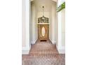 Inviting entryway featuring a wood door with glass, brick steps, and overhead lighting at 2170 Lake Marion Dr, Apopka, FL 32712