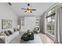 Cozy living room with a murphy bed, large windows, and a ceiling fan for comfort at 2170 Lake Marion Dr, Apopka, FL 32712