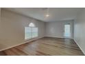 Bright bedroom featuring laminate flooring and a window at 105 Evergreen Dr, Auburndale, FL 33823