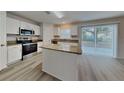 Modern kitchen features stainless appliances, granite counters and center island at 105 Evergreen Dr, Auburndale, FL 33823