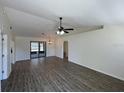 Spacious living room featuring vaulted ceiling and sliding glass doors to porch at 11757 Se 71St Terrace Rd, Belleview, FL 34420
