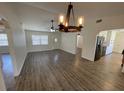 Living room features wood flooring and an open layout that connects to the kitchen at 11757 Se 71St Terrace Rd, Belleview, FL 34420