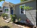 Charming single-story home with a blue front door, neat landscaping, and a welcoming facade at 1960 Hamilton St, Bartow, FL 33830