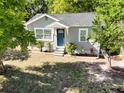 Charming single-story home with a blue front door and well-maintained landscaping at 1960 Hamilton St, Bartow, FL 33830