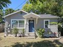 Cozy single-story home with a blue front door, neat landscaping, and a welcoming facade at 1960 Hamilton St, Bartow, FL 33830