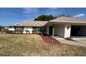 Charming single-story home featuring a well-manicured lawn and lovely landscaping at 3210 Se 54Th Cir, Ocala, FL 34480