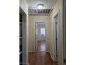 Hallway with hardwood floors leads to rooms with natural light streaming through the windows at 1710 Hamilton St, Bartow, FL 33830