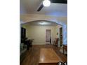 Inviting living room features hardwood floors, decorative archways and a ceiling fan at 1710 Hamilton St, Bartow, FL 33830