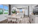 Bright dining room featuring a view to the kitchen, wood floors and natural light at 5844 Sw 87Th Ave, Ocala, FL 34481